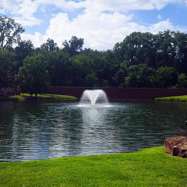 Scott Aerator North Star Aerating Pond Fountainin in pond with trees in background