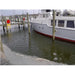 Boat in icy water at dock with ice around the boat cleared away by Ice Eater P750