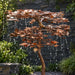 Close-up of hand-cut copper maple leaves with water droplets