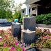 Blue Thumb triple boulder bird bath fountain kit in a garden