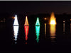 Vanguard Majestic Floating Christmas Trees lit up on a pond at night