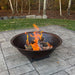 Cast iron sugar kettle bowl used as a wood-burning fire pit
