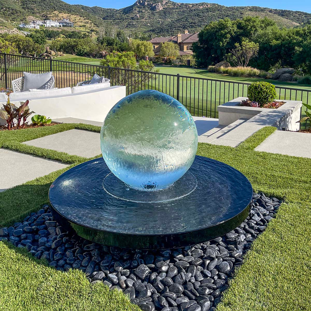 Blue Thumb 24 inch crystal acrylic sphere fountain kit in a landscape