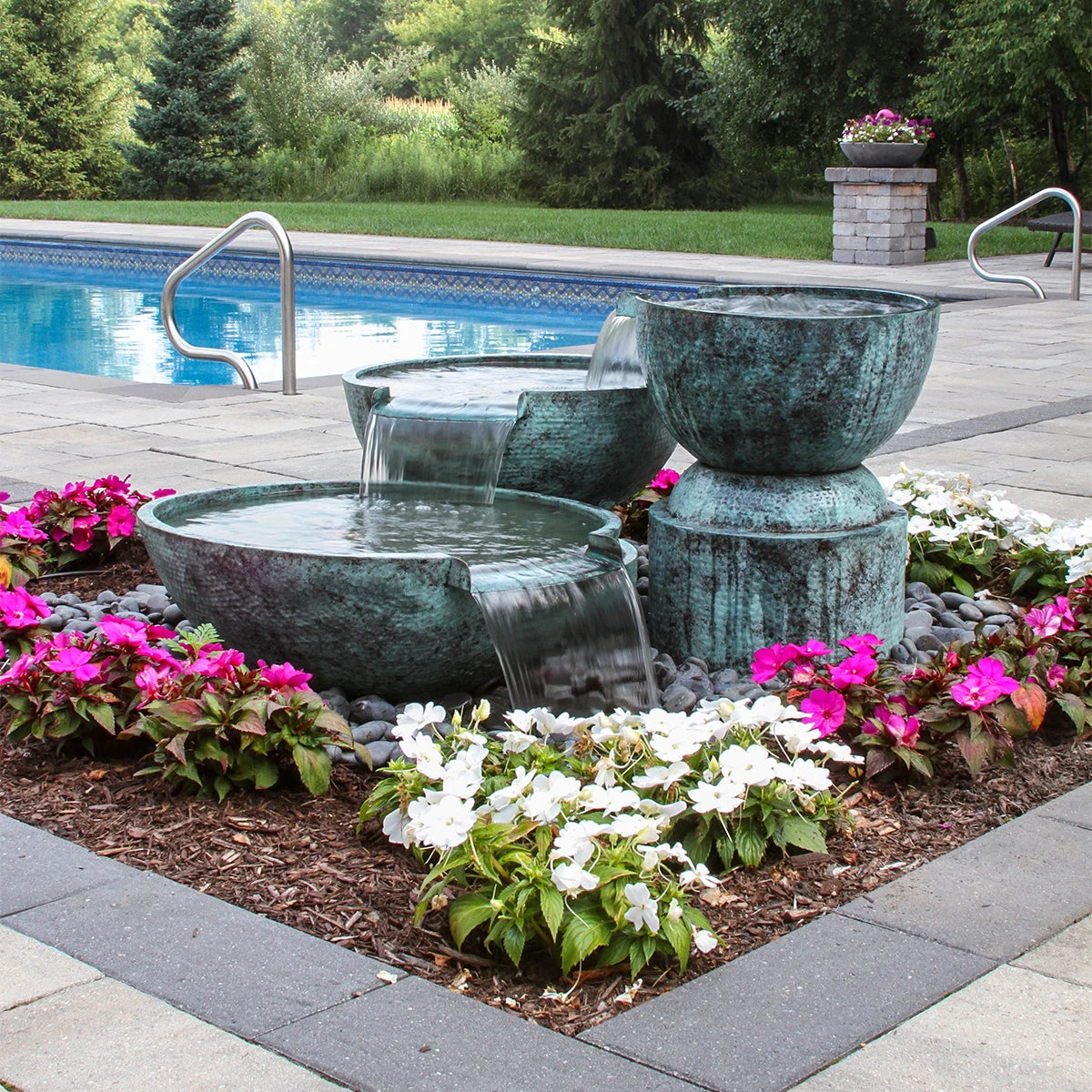 Blue Thumb triple brass spillway bowl fountain kit cascading in a garden