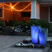 Tapered square triple urn fountain lit at night