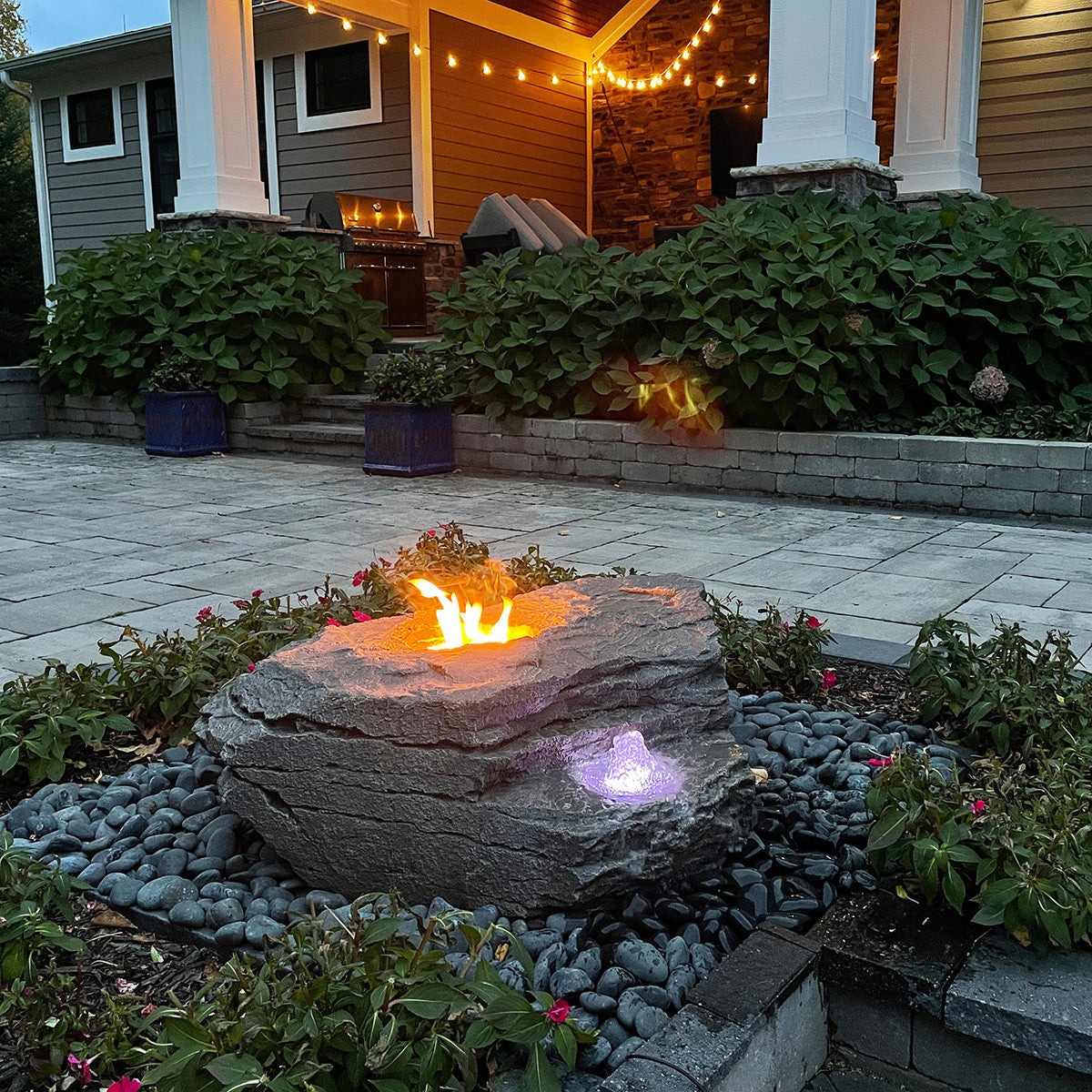 Fire and Water boulder fountain at night with lights