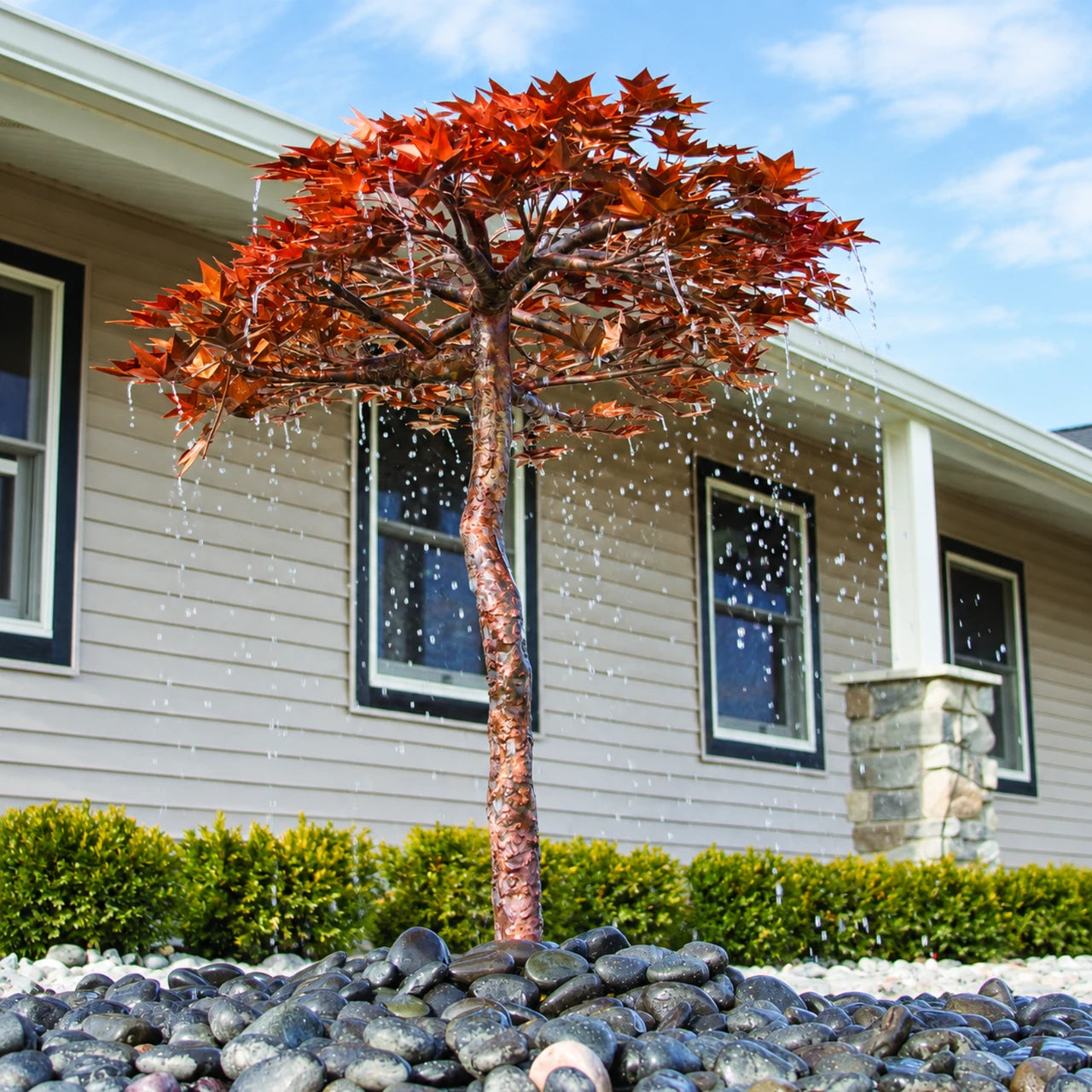 Copper Japanese maple fountain with water flowing from hand-cut leaves