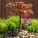 Blue Thumb copper Japanese maple tree fountain in a landscaped garden