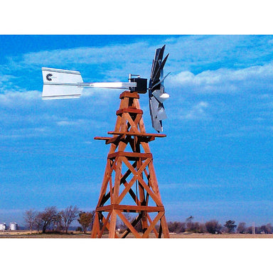 Outdoor Water Solutions Wooden windmill pond aerator against a blue sky with clouds