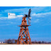 Outdoor Water Solutions Wooden windmill pond aerator against a blue sky with clouds