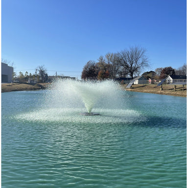 Outdoor Water Solutions Commercial Aerating Fountain in a pond with a clear blue sky