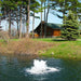 Scott Aerator Boilermaker in  pond next to Log cabin with trees in the background