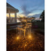 Copper extra tall oak tree fountain lit at night