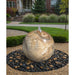 30 inch yellow onyx sphere fountain in a garden setting
