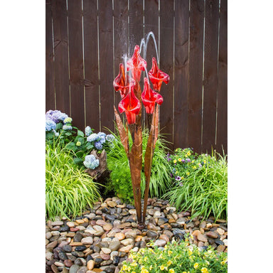 Copper fountain with red glass iris flowers