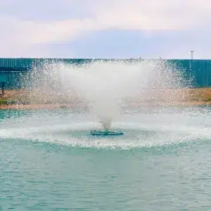 Outdoor Water Solutions Commercial Aerating Fountain in a body of water with a blue sky in the background