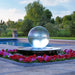 24 inch crystal sphere fountain beside a pool with red flowers