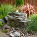 Blue Thumb Mountain Spring GFRC boulder fountain in a landscape