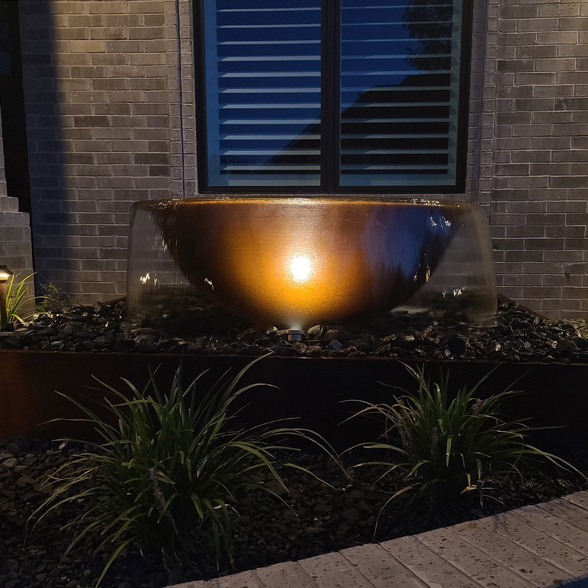 Sugar kettle fountain lit at night